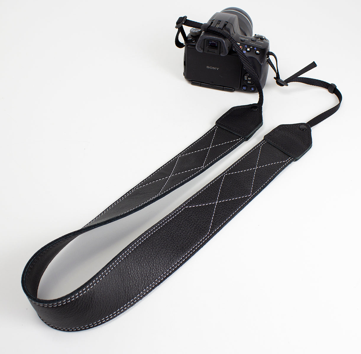 Black / white stitched leather camera strap.