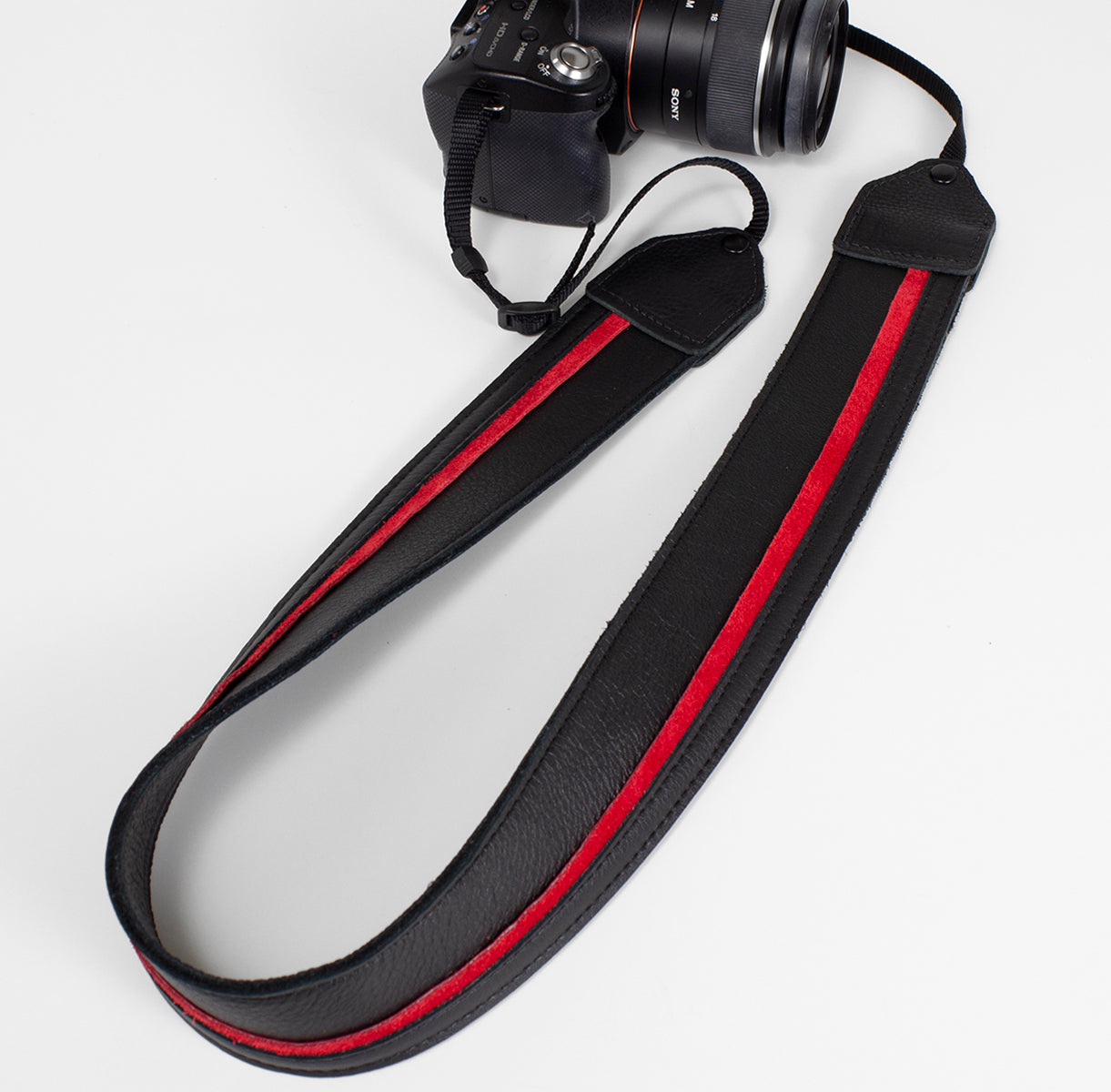 Black / red racing stripe leather camera strap.