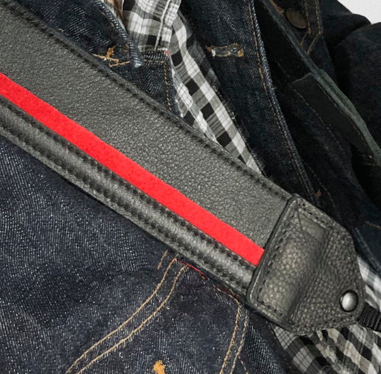 Black / red racing stripe leather camera strap.