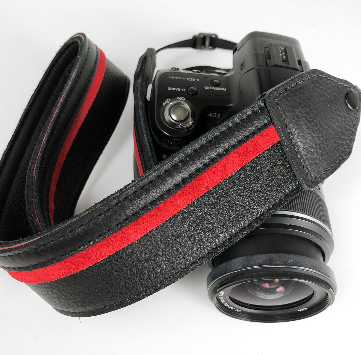 Black / red racing stripe leather camera strap.