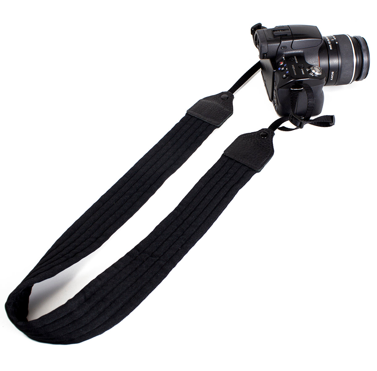 Black pleated nylon camera strap.