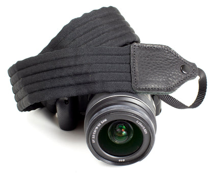 Black pleated nylon camera strap.