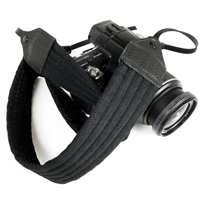 Black pleated nylon camera strap.