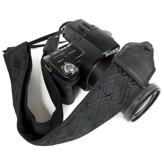 Black / black geometric jacquard camera strap.
