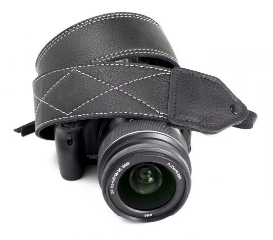 Black / white stitched leather camera strap.