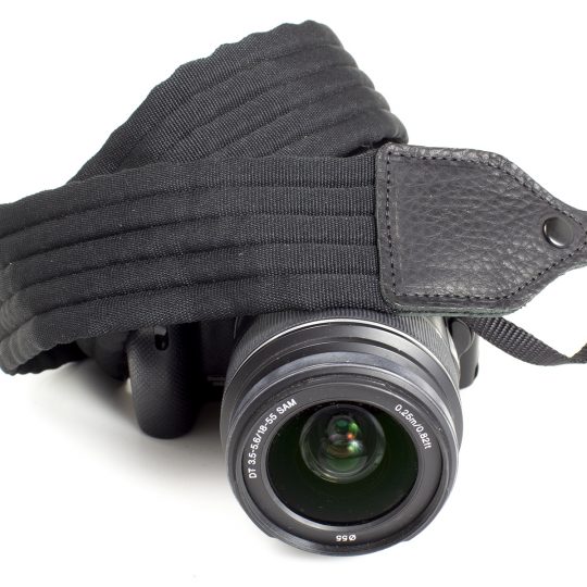 Black pleated nylon camera strap.