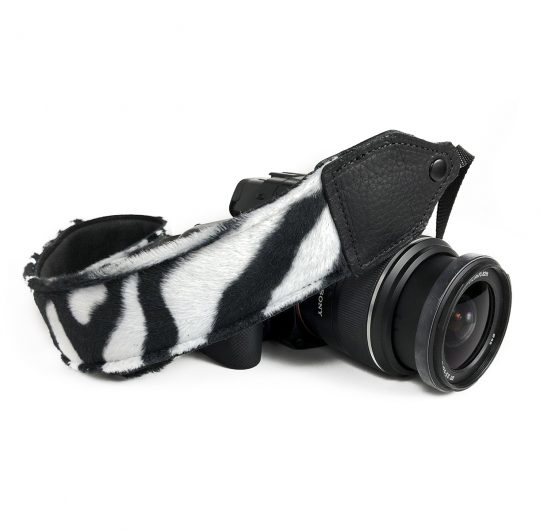 Black / white zebra faux fur camera strap.